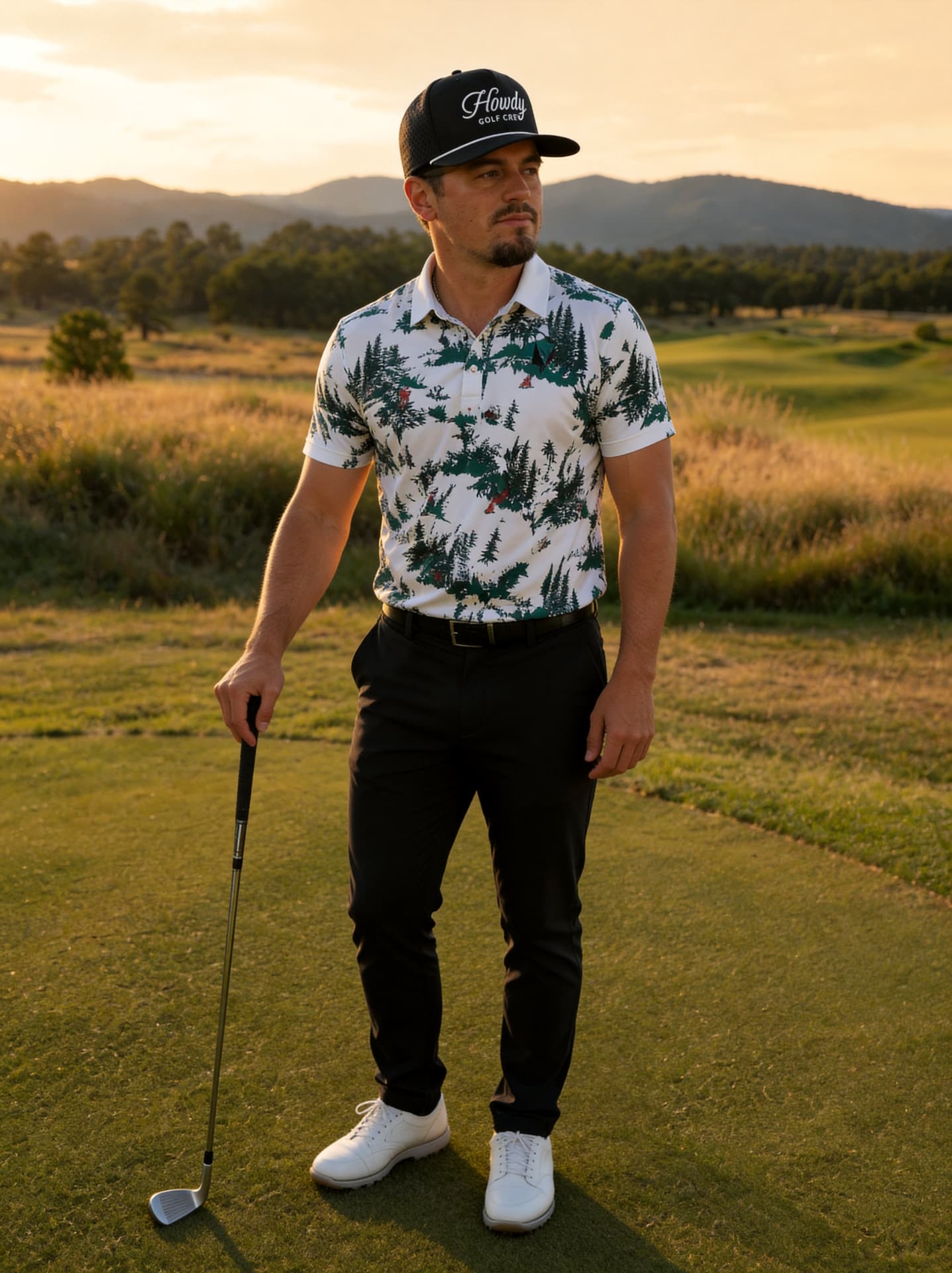 Golfer in a Howdy Golf Crew hat and printed polo on the tee at golden hour